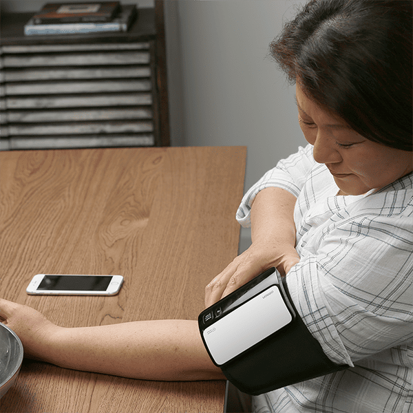 Person using an OMRON Evolv blood pressure monitor at home